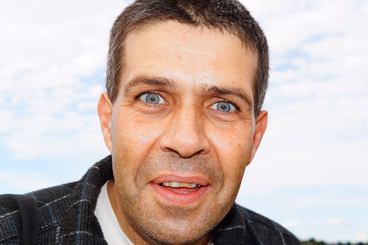 A confused man looking towards the camera
